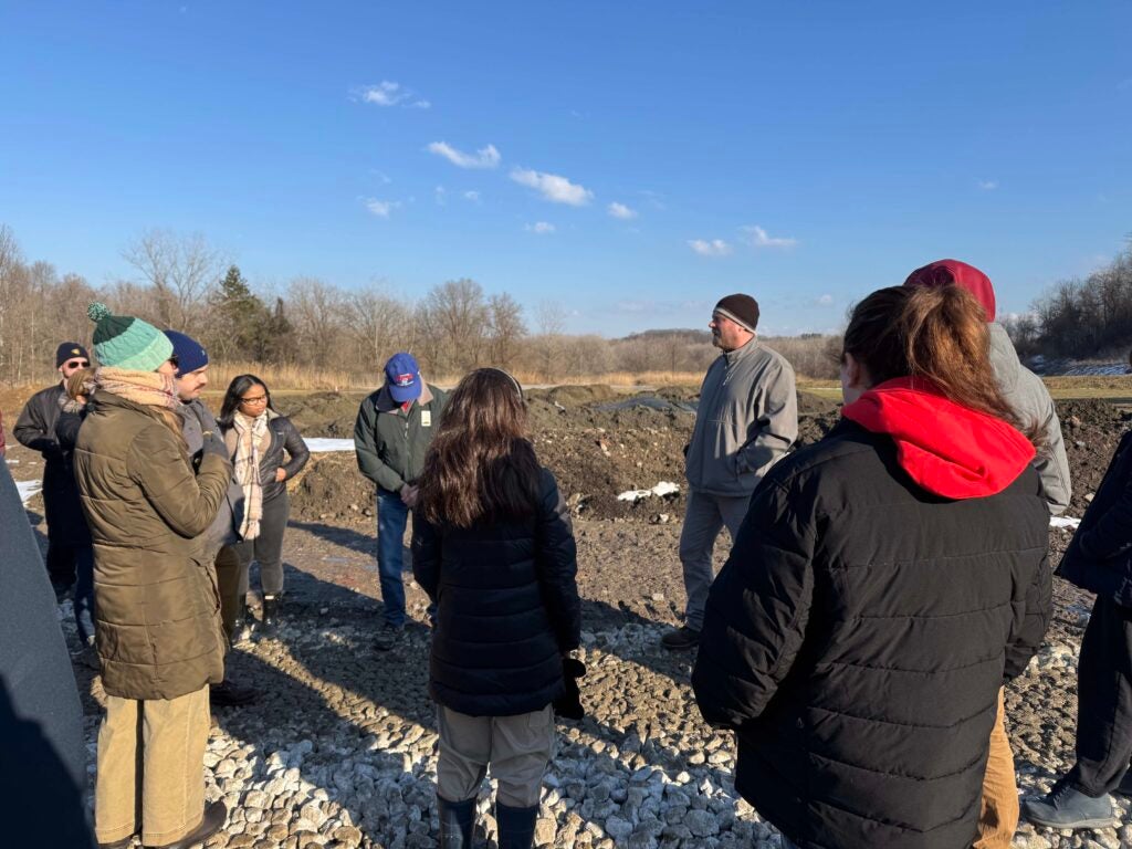 Group of students listening to information about the site